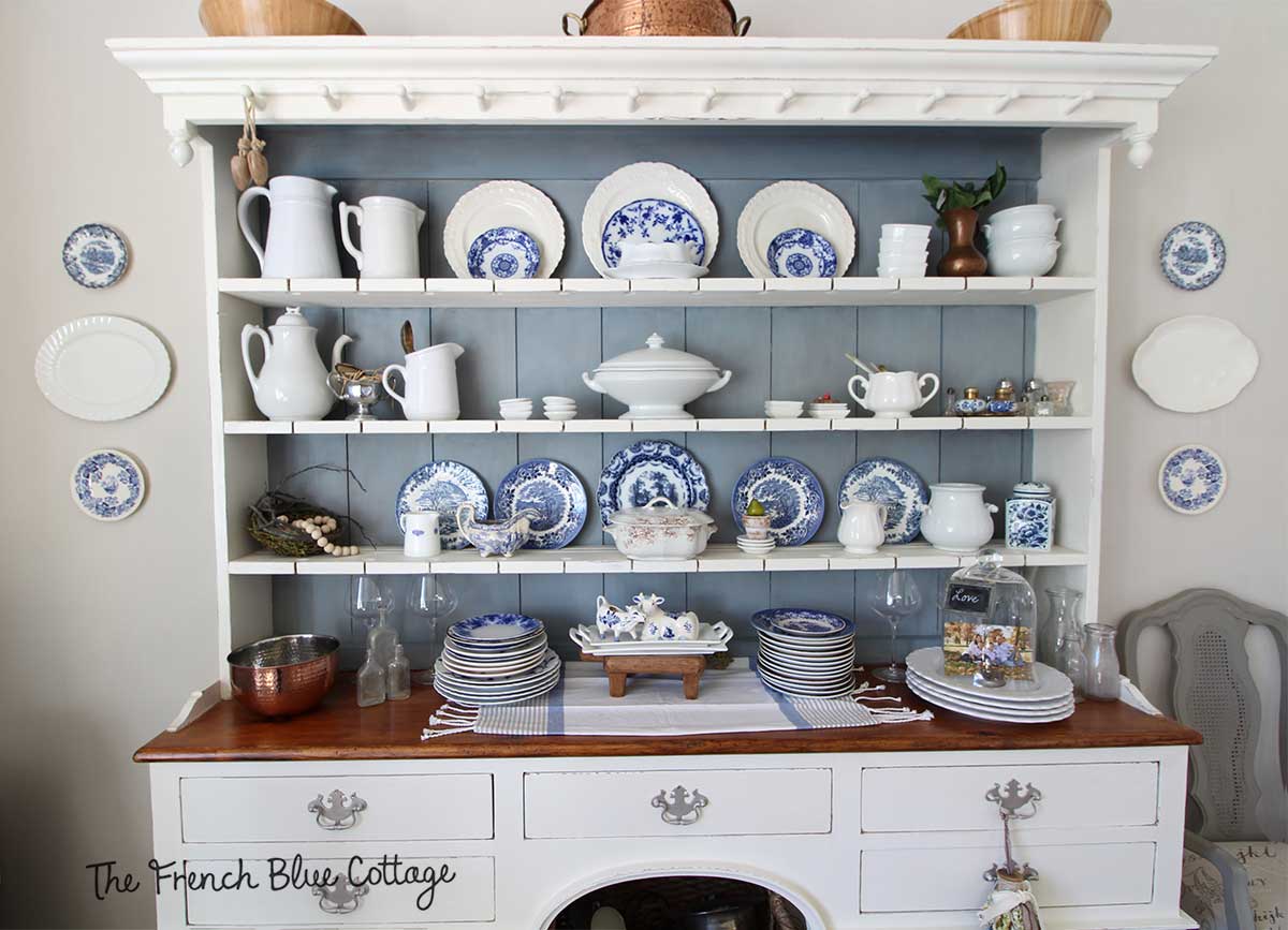 Welsh cupboard china cabinet with blue and white plates.