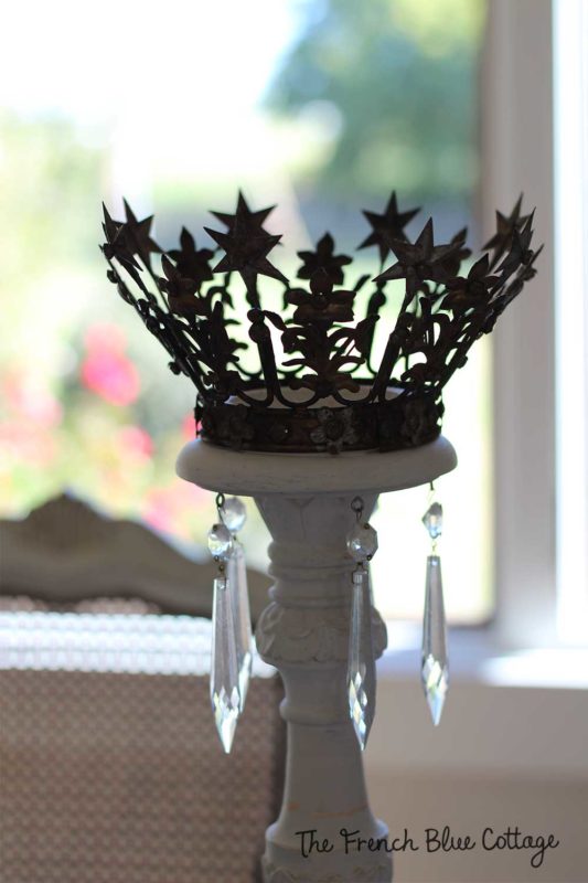 tall white candlesticks with gold crowns on top