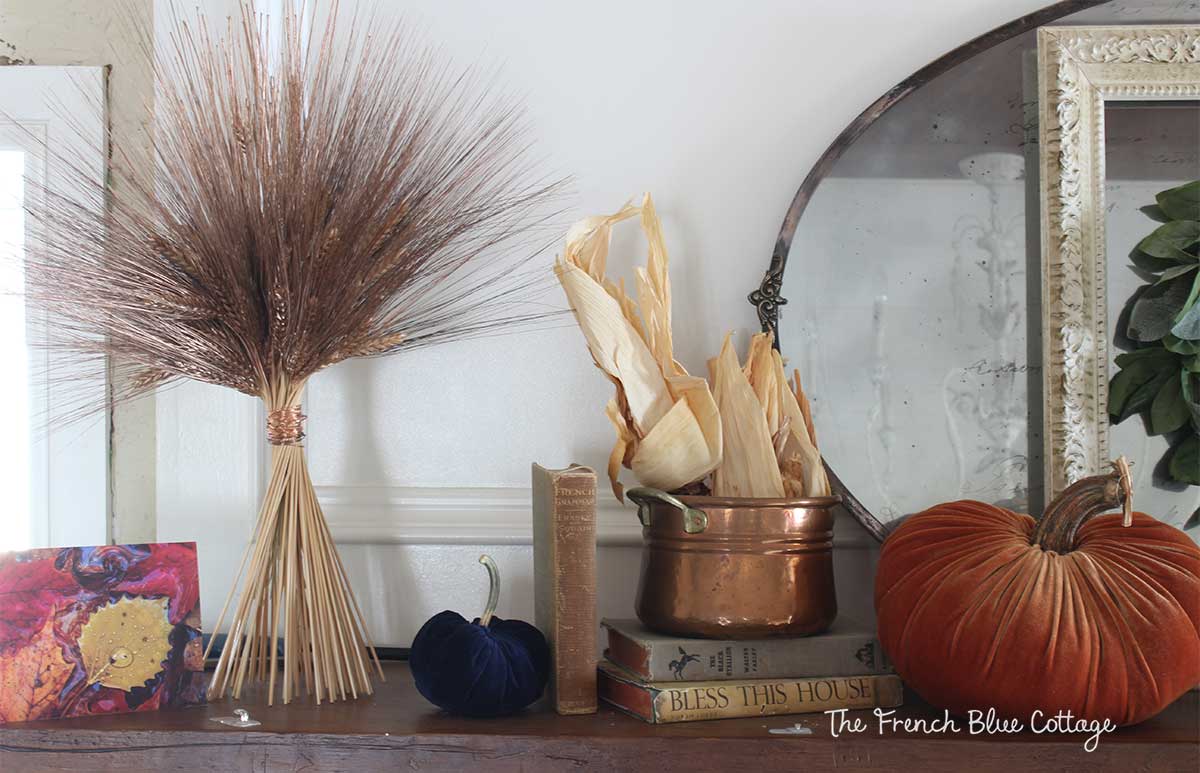 Copper wheat bundle wrapped with copper wire on a fall mantel.