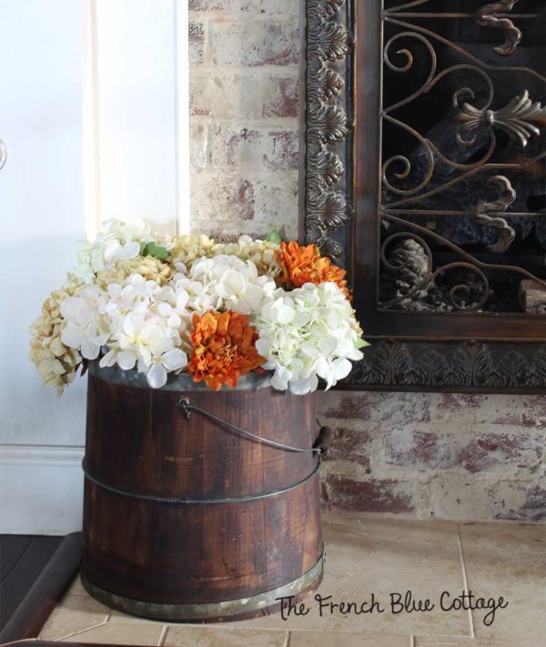 Wood bucket with fall flowers.