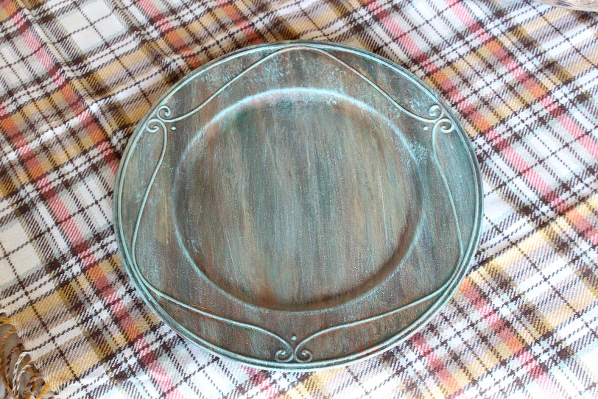 Table plate charger with verdigris paint finish.