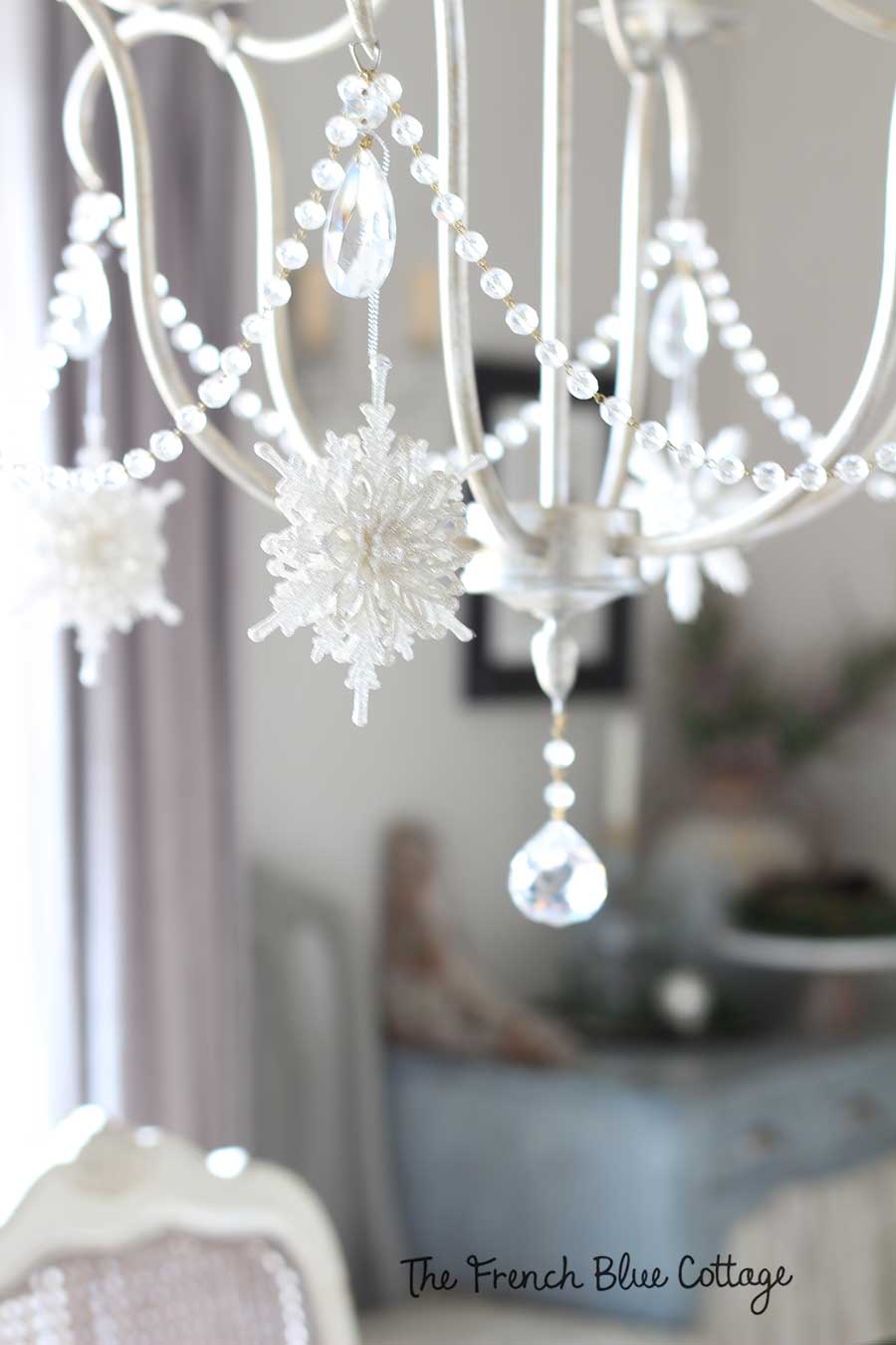 Glittery snowflakes on a chandelier for Christmas.