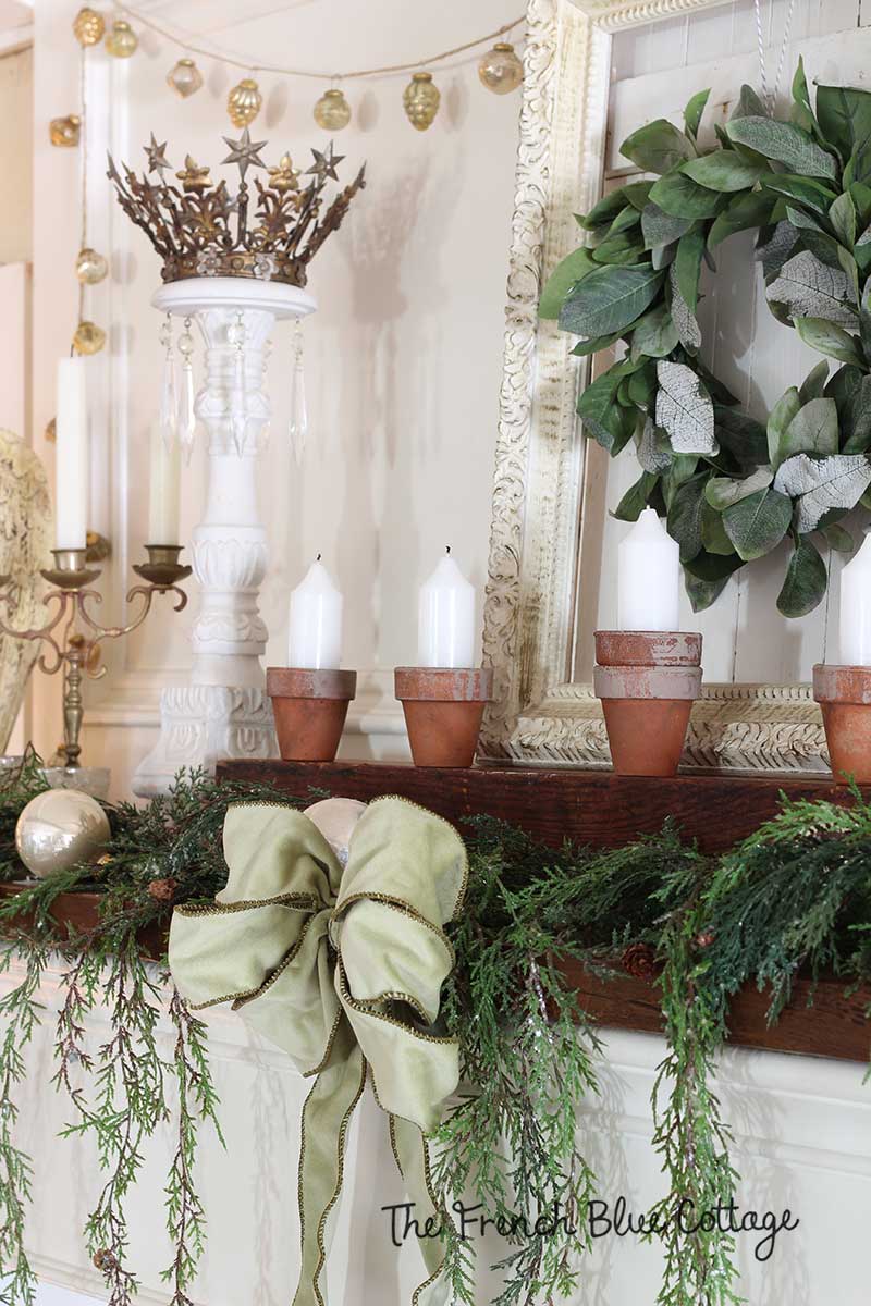 French country mantel with clay pot candles.