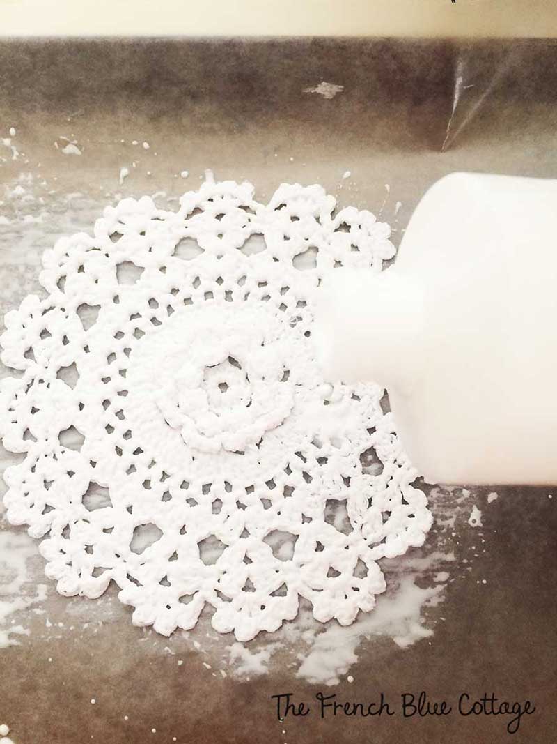 Doily with fabric stiffener to make snowflakes.