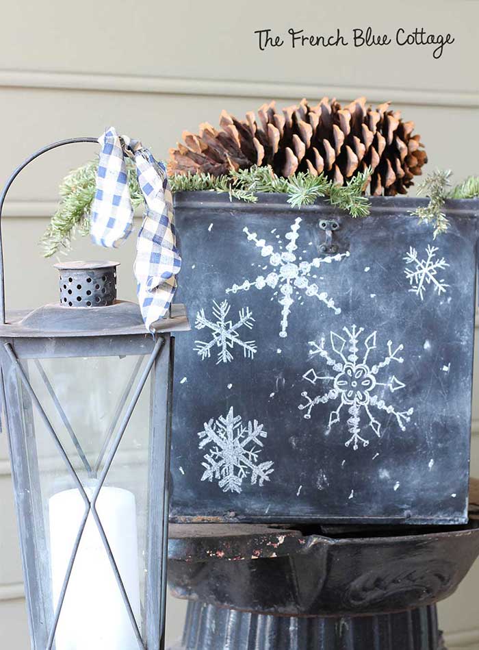 Chalkboard box on winter porch with snowflakes.