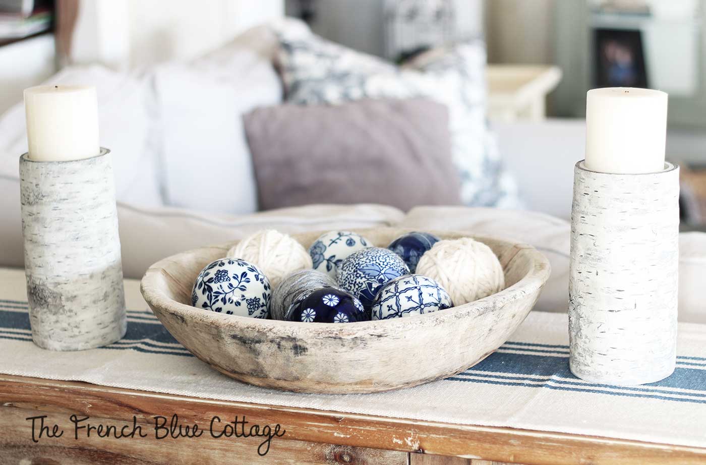 Textural winter vignette with yarn, birch, and blue ceramic.