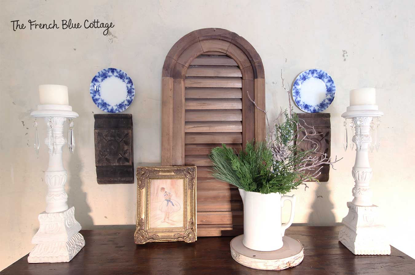 Winter decor with flow blue plates on top of a hutch.