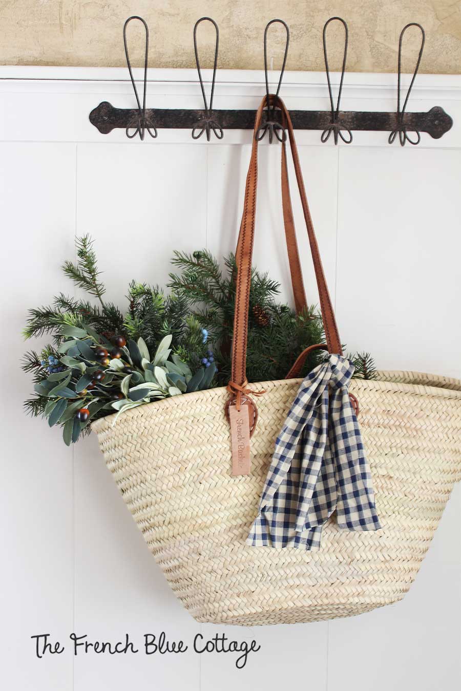 Hanging basket in the entry with evergreens and gingham.