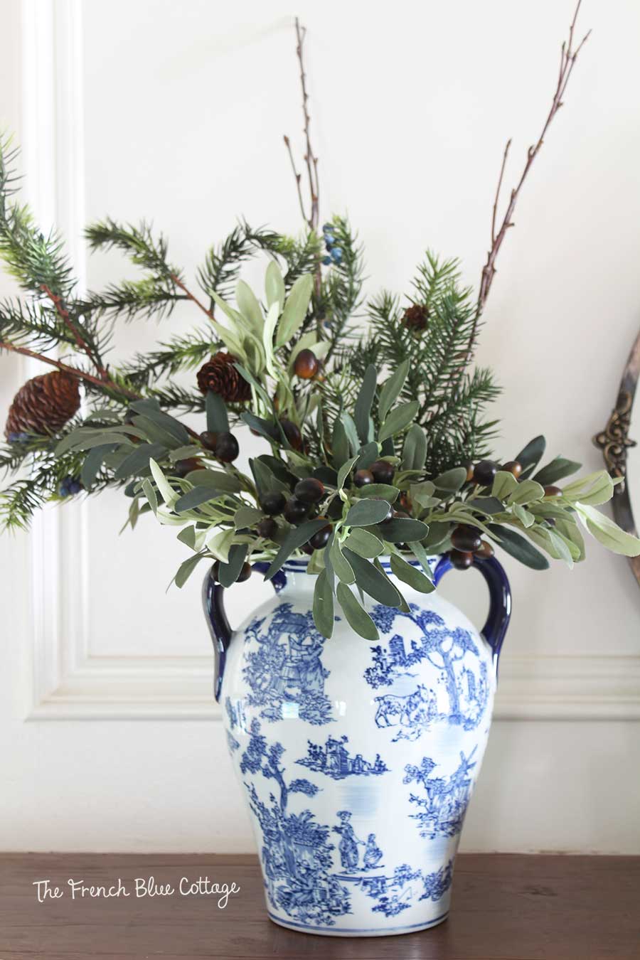 Winter greenery arrangement with olive branches.