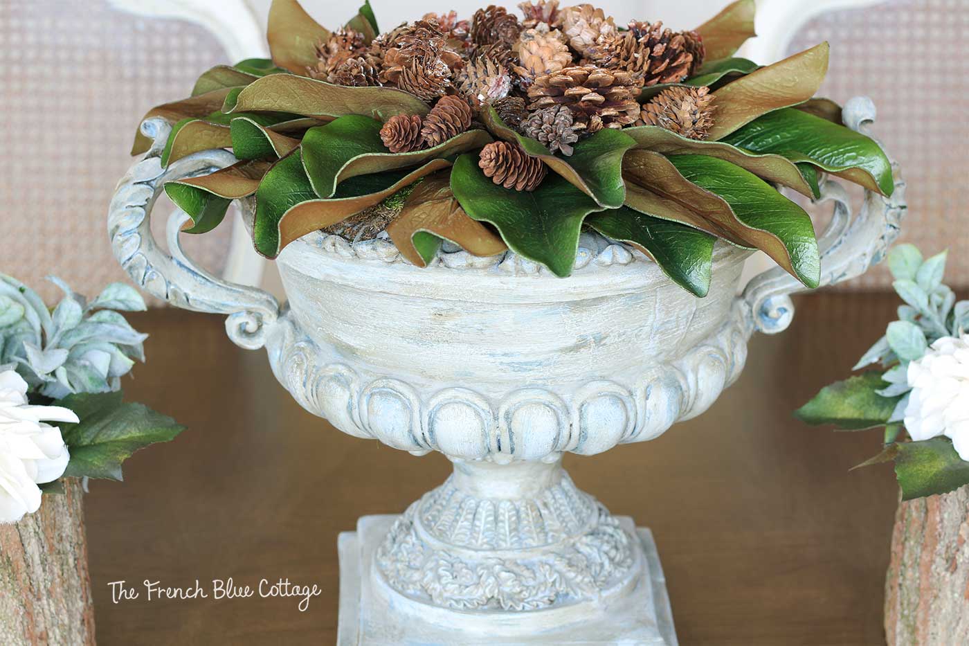 Winter urn with magnolia leaves and pinecones.