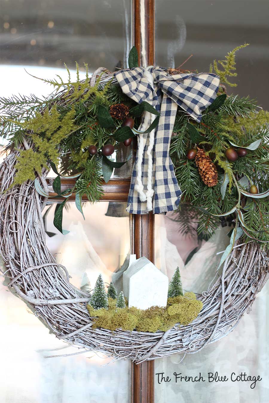Gingham and yarn bow on winter wreath.
