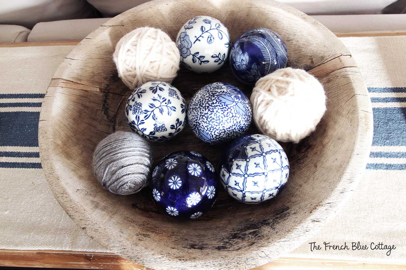 Yarn and ceramic balls in a rustic bowl.