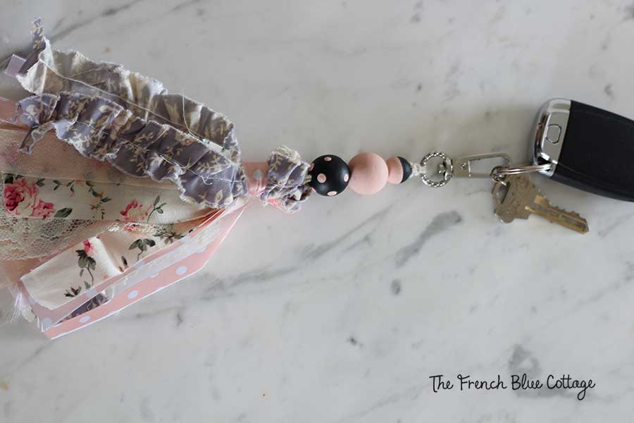 Wood beads and ribbon tassel keychain.