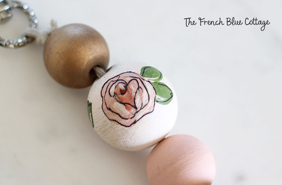 Hand painted rose on a wood bead for a DIY keychain.
