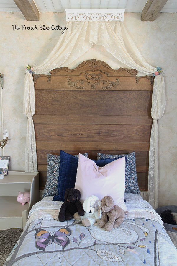 girl's bed with antique headboard