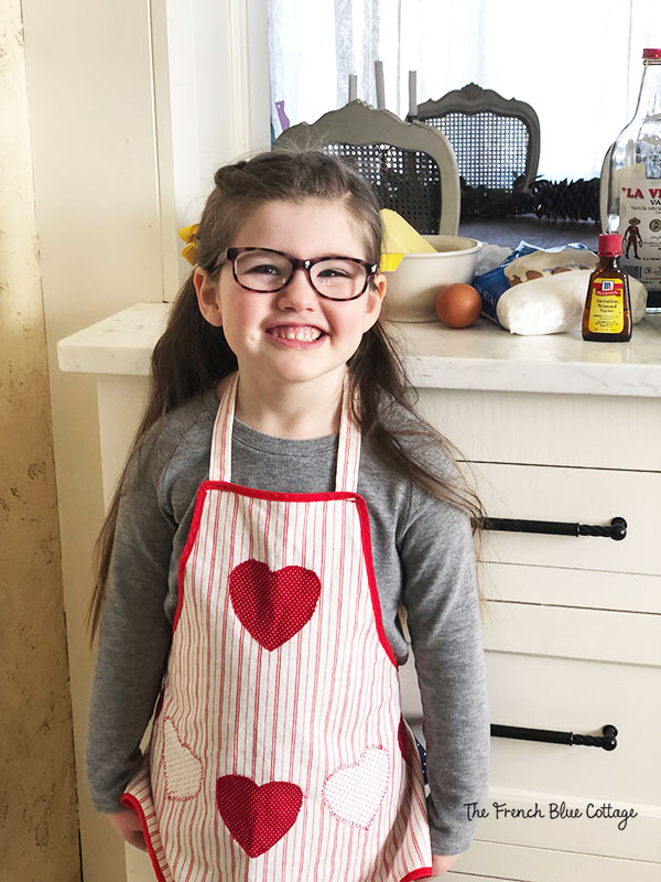 little girl in Valentine's apron