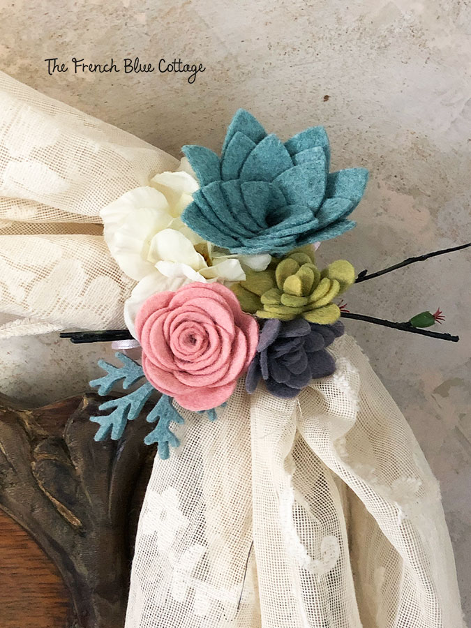 felt flowers decorating an antique headboard