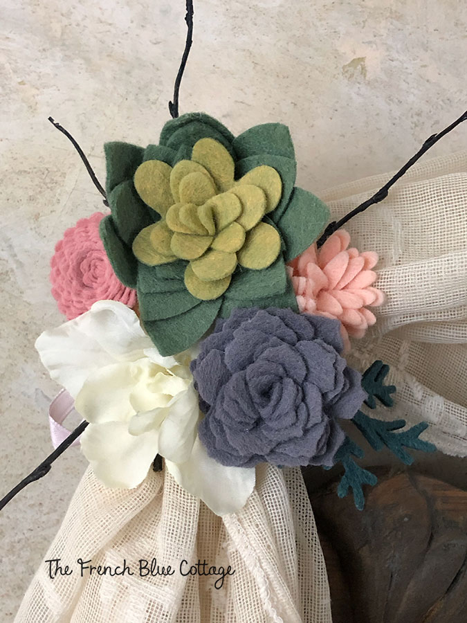 felt flowers embellishing an antique bed