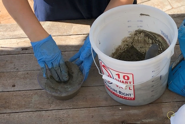 placing concrete in a bowl to make a jewelry holder