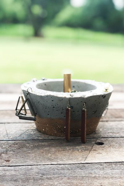 diy jewelry bowl from concrete with earrings hanging around the sides