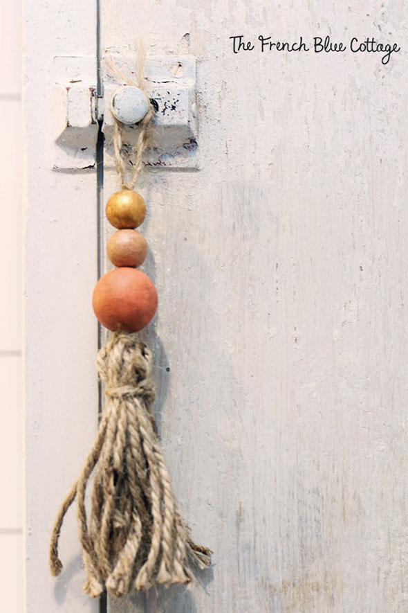 twine and bead tassel hanging from bathroom cabinet