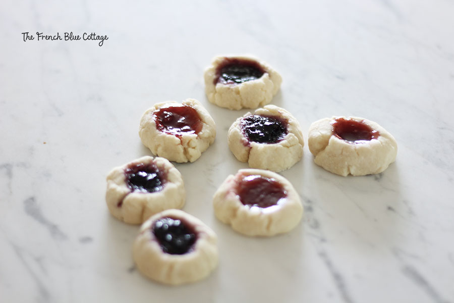 thumbprint jam cookies on a marble counter