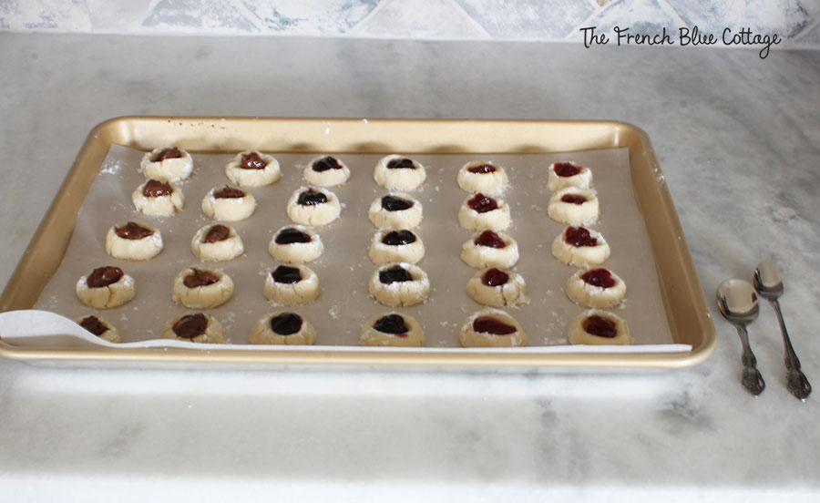 thumbprint shortbread cookies with jam and chocolate in the center