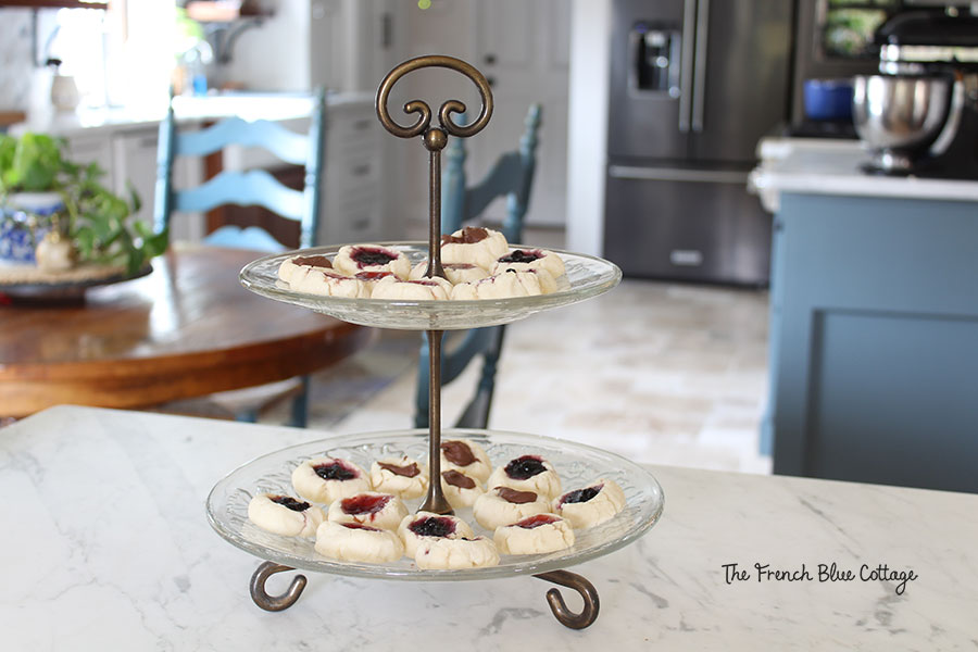 thumbprint cookies on a two tiered serving tray