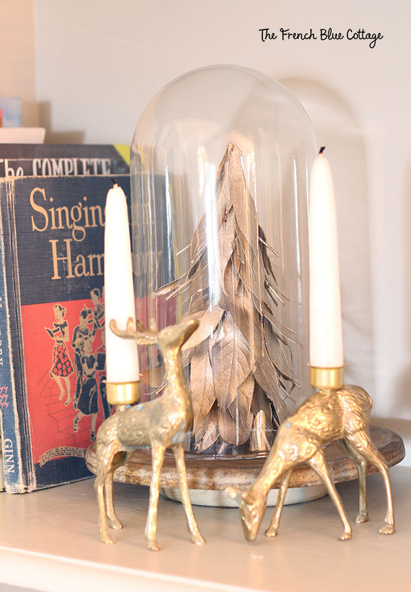 French country Christmas decor with brass deer and gold tree under cloche