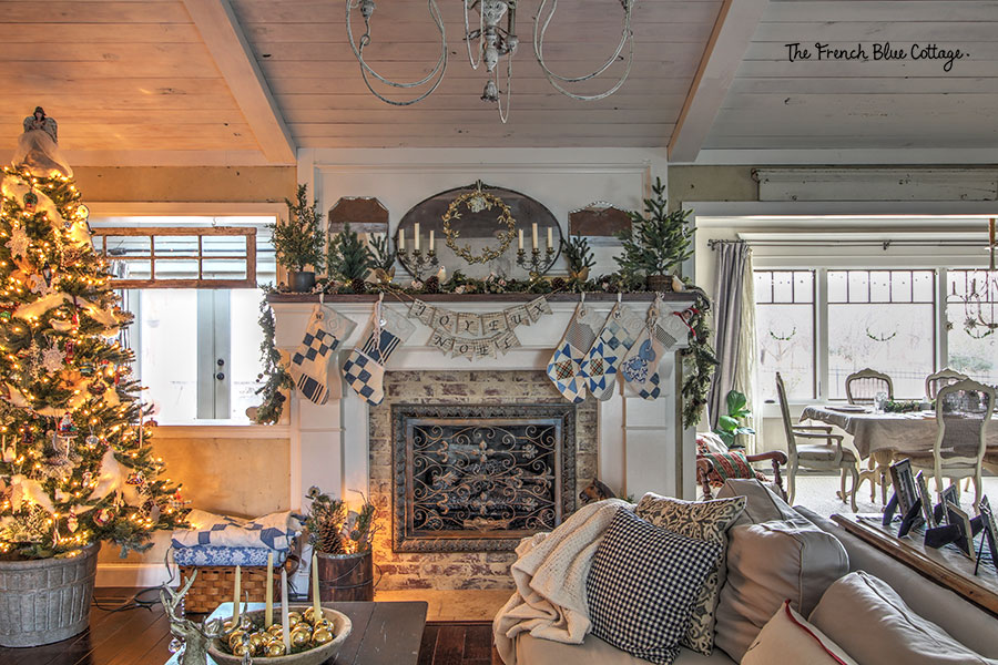 French country Christmas decor in living room with glow from tree