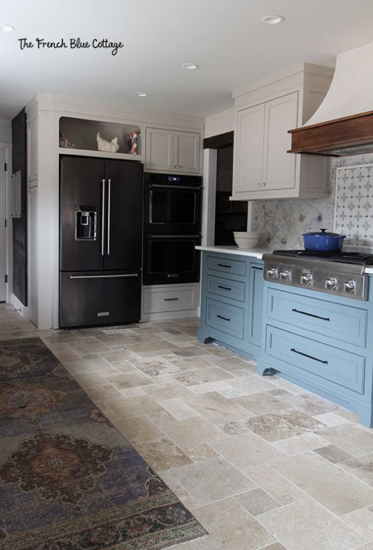 refrigerator and double oven in remodeled french country kitchen