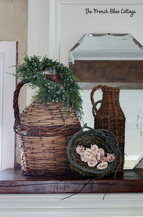 two wicker jars and a nest with pink flowers