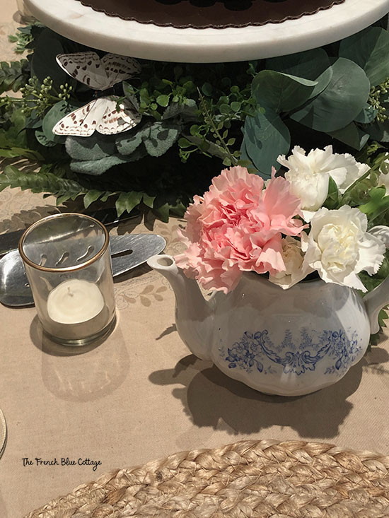 small blue and white teapot with flowers