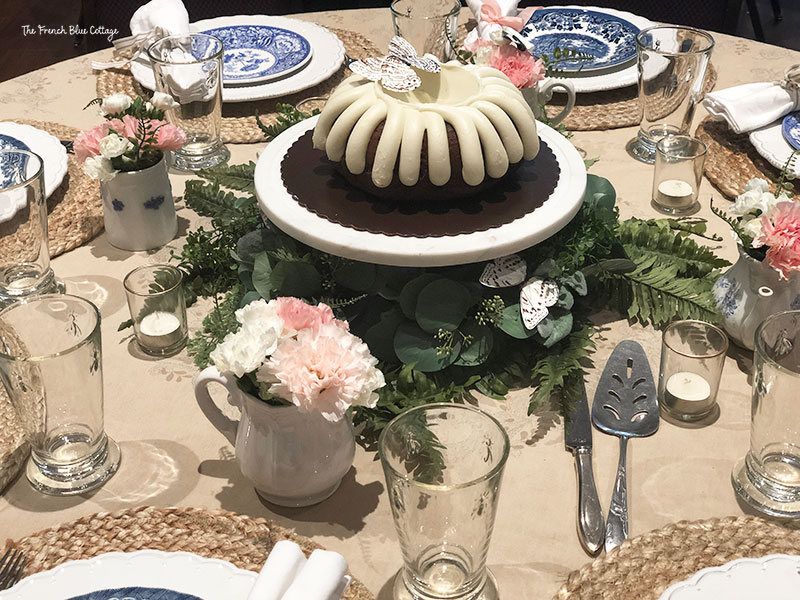 bundt cake with wreath around bottom of cake stand