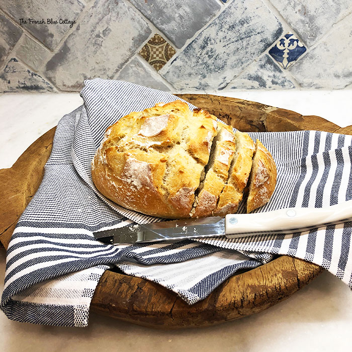 homemade bread on a round breadboard
