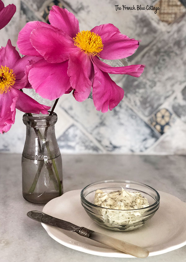 bowl of herb butter and vase of peonies
