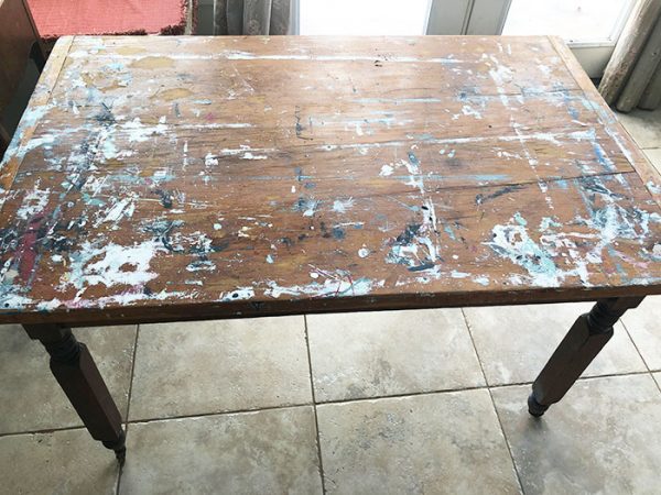 old pine table with paint all over the top
