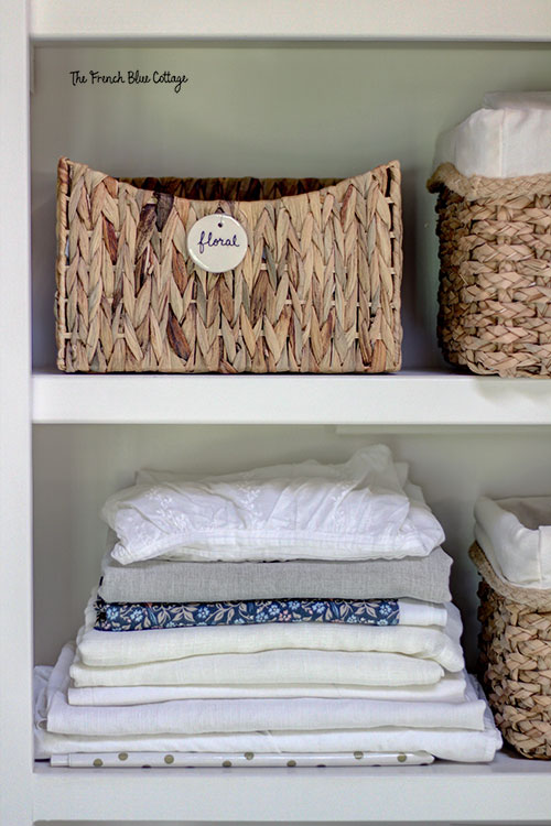 air dry clay tags organizing baskets on a bookshelf