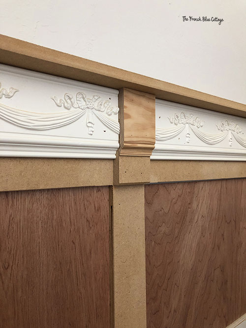 carved wood trim and moulding on staircase wall