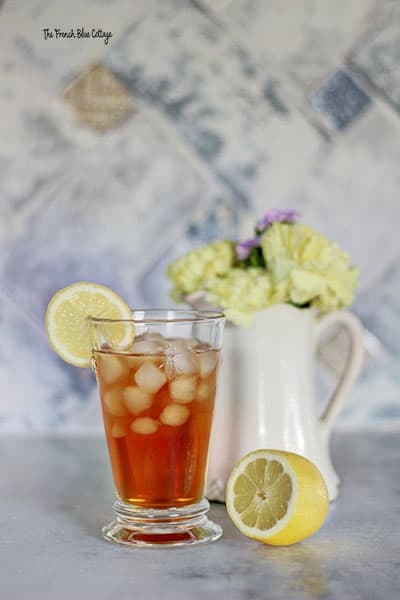 sweet tea with a pitcher of flowers and a lemon