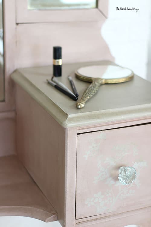 pink antique vanity with stenciled drawers