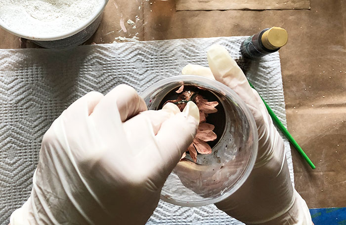 antiquing glaze on plaster flowers dunked in cup