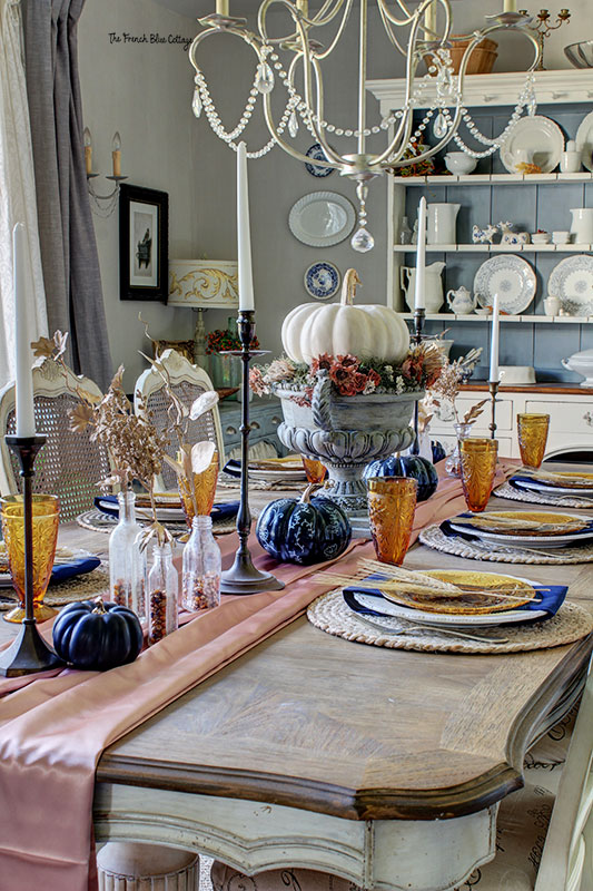 fall table in earth-toned color palette and with a satin table runner