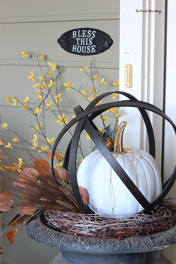 faux metal orb made from embroidery hoops with a pumpkin inside